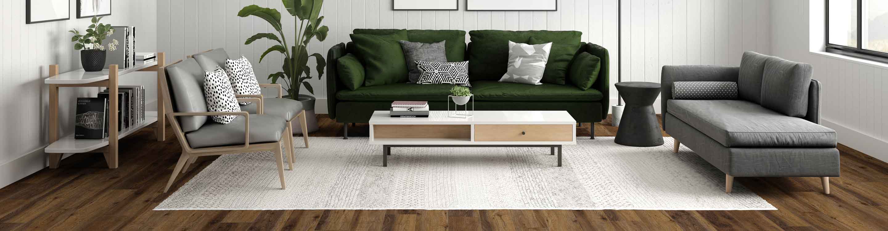 Beige area rug in a living room with an emerald green couch