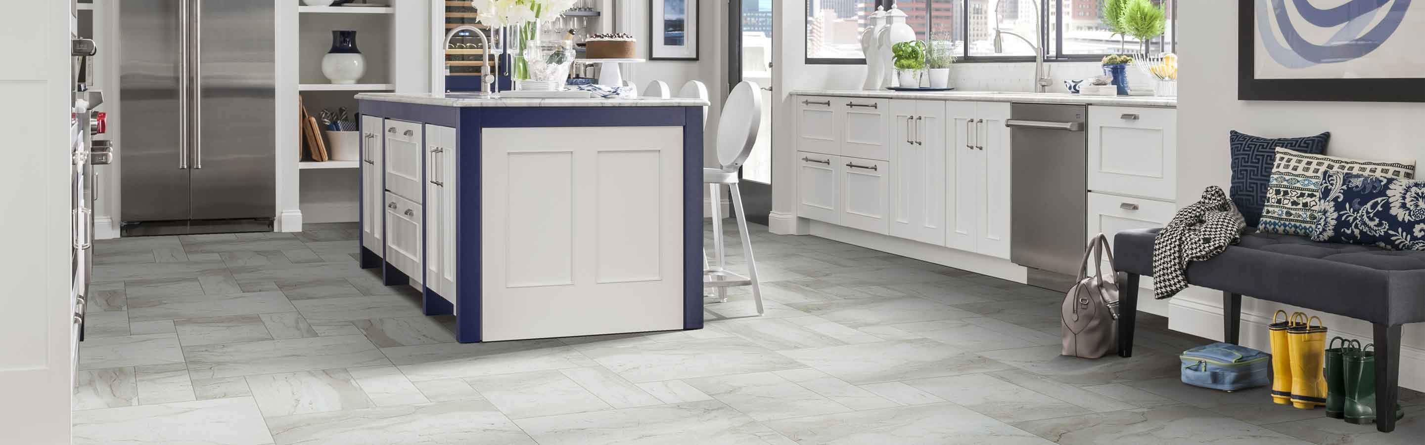 Kitchen with gray tile floors and white cabinets