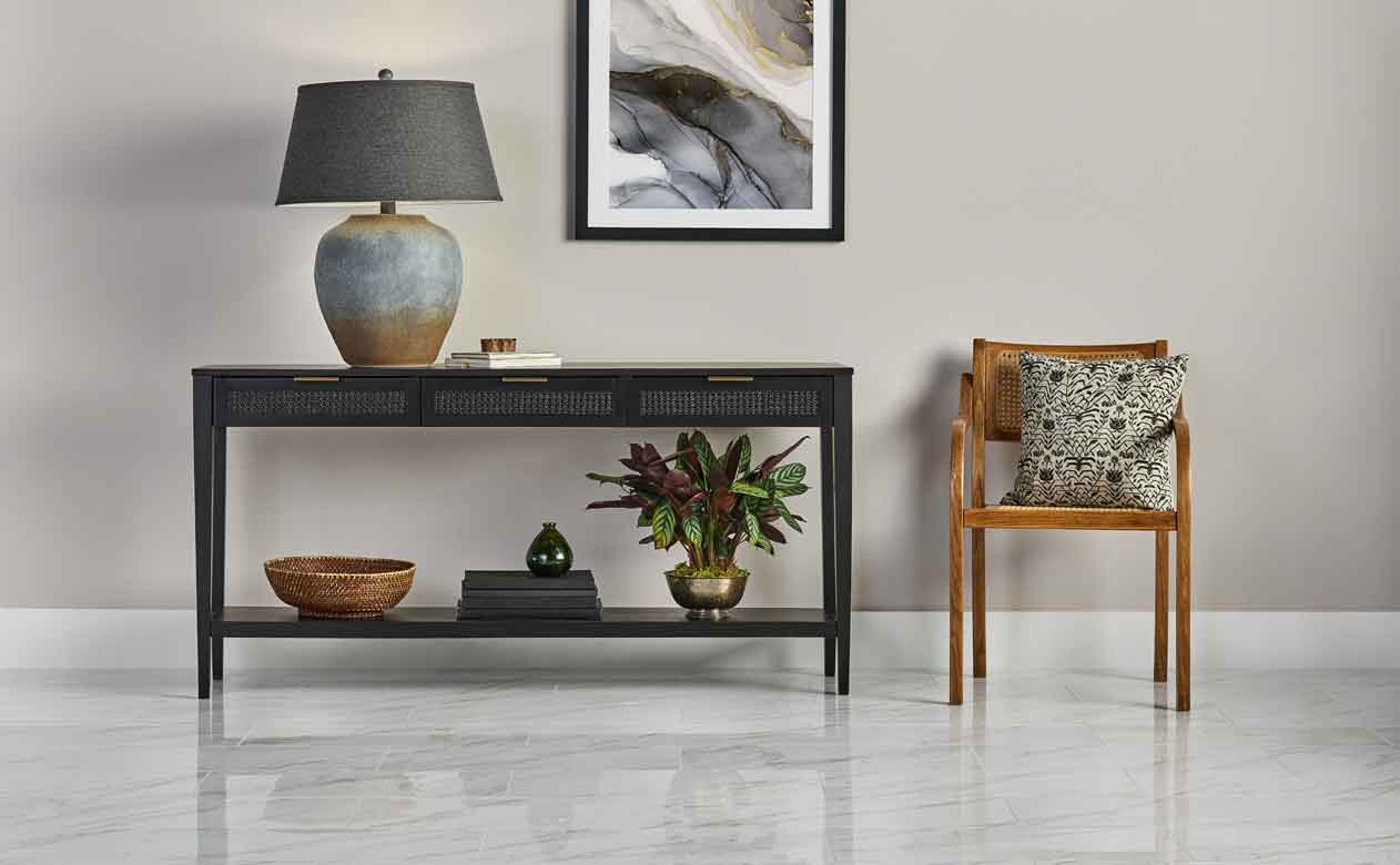 Marble floor with side table and lamp and chair. 