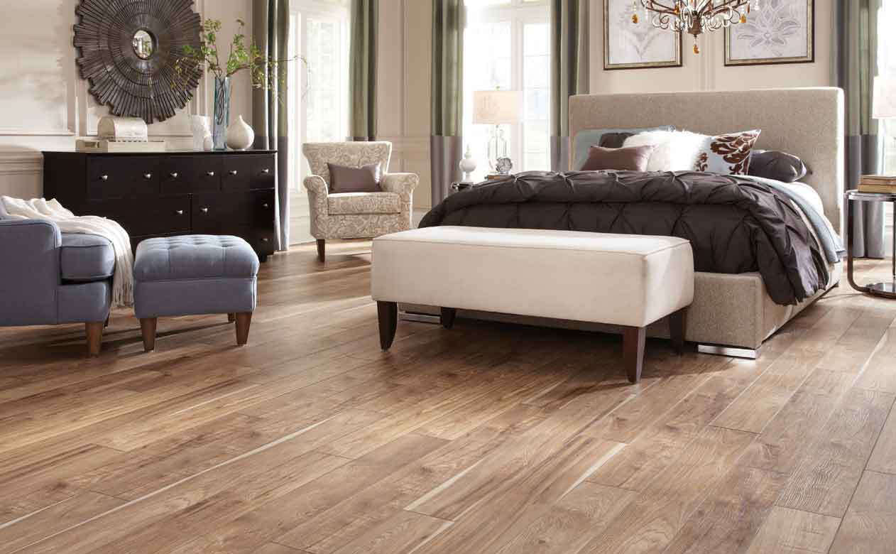 Neutral master bedroom with tiles that look like wood plank floors. 